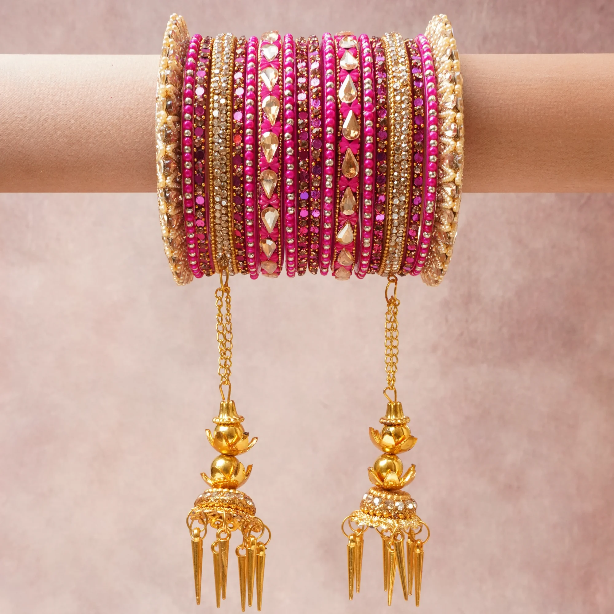 A commanding Rani Pink anchors this beautiful set, enriched with accents of Bright Gold, Champagne Crystal, Off-White Pearl that add depth and dimension.

Featuring a striking composition of Gold-Plated Alloy, Glass Rhinestones, Silk Thread, Seed Beads, Imitation Pearls, this set carries intricate craftsmanship and strong presence. Grand in form, it is created for moments that deserve to be marked.